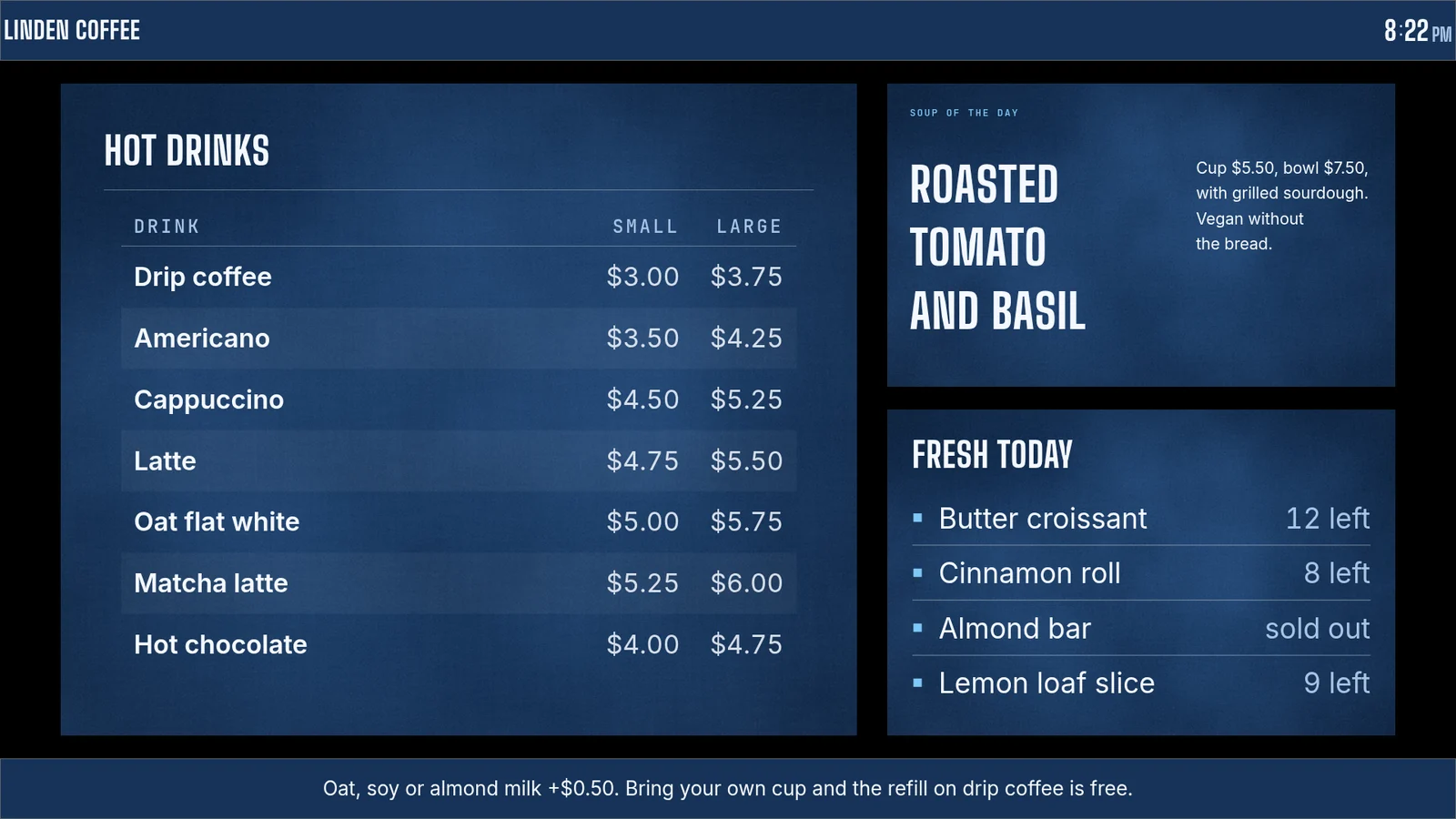 A blue counter board: header with clock, hot drink prices, soup of the day, a bakes list with the almond bar sold out, and a milk notice in the footer.