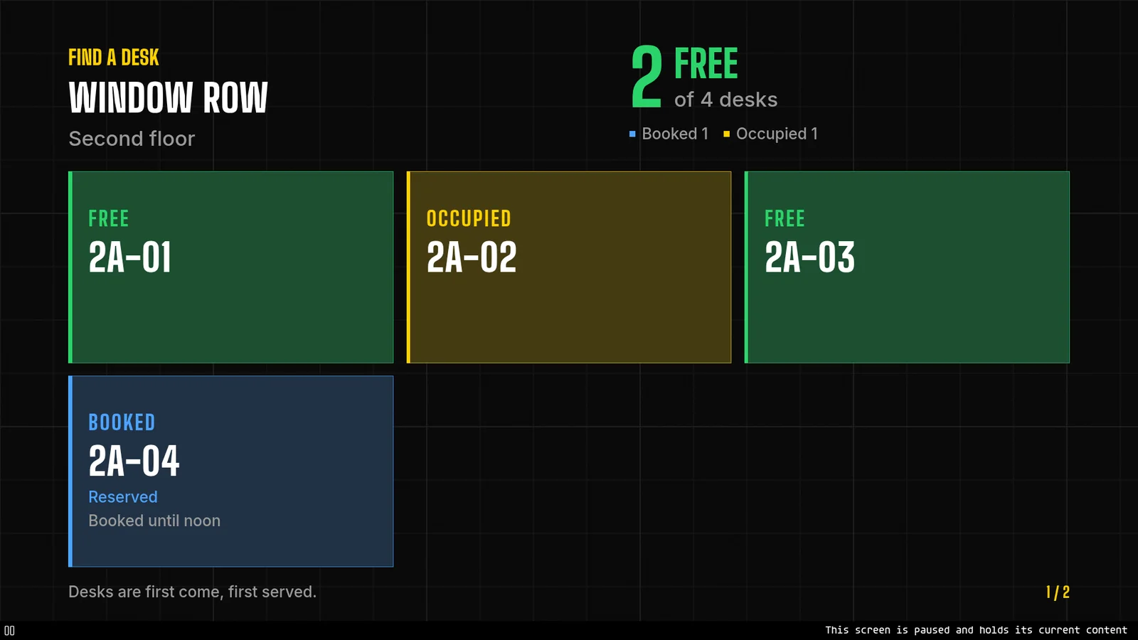 A paused desk board with four desk tiles, and along the bottom a pause mark and the line This screen is paused and holds its current content